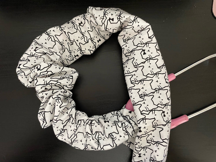 White scrunchie-style stethoscope cover fits both intact and detachable bells on a pink-stemmed stethoscope.